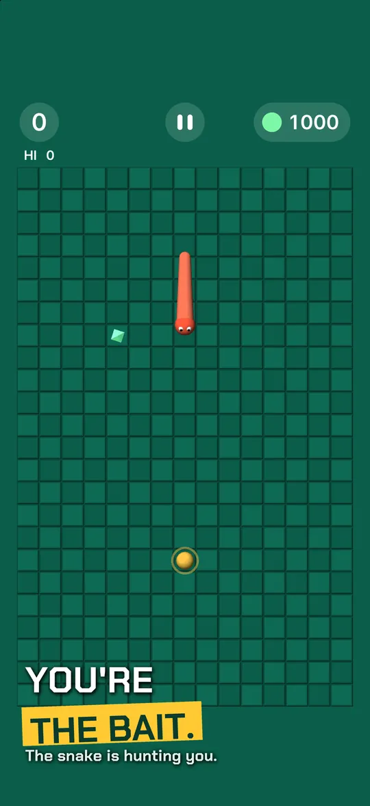 Caption: YOU'RE THE BAIT. The snake is hunting you. A red snake chases the bait across the green Studio board.